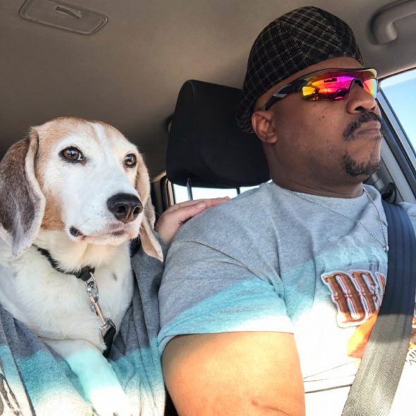 Pierre Young, 51, of Milwaukee is seen with his 15-year-old beagle, Duncan. Young says Duncan used to travel with him to work — when he had a job. Young lost his part-time ministry warehouse job during the pandemic and sold his two aging trucks to make rent. Now his lack of transportation is hindering his work search. Credit: Courtesy of Pierre Young