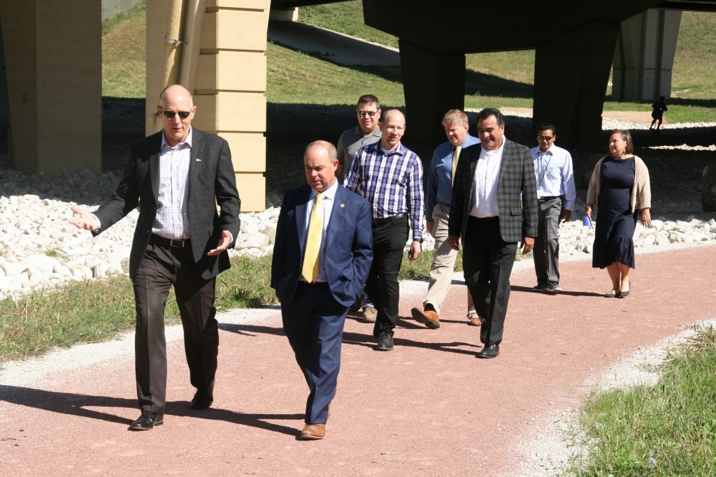Public Works Commissioner Jeff Polenske and WI Transportation Secretary Craig Thompson lead a group on a tour of green infrastructure improvements under the Marquette Interchange. Photo by Jeramey Jannene.
