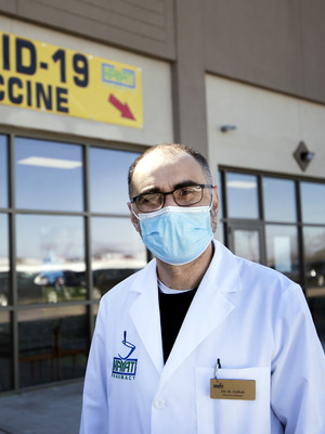 Pharmacist Hashim Zaibak stands outside of Hayat Pharmacy where COVID-19 vaccines and testing are offered Thursday, March 11, 2021, in Milwaukee, Wis. Angela Major/WPR