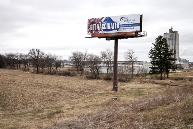 A billboard on the side of Highway 26 in Rock County encourages people to get the COVID-19 vaccine. Angela Major/WPR