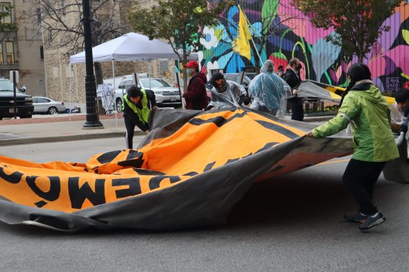 Demonstrators begin to block the street with banners and their own bodies during an immigration reform protest in Milwaukee. Photo by Isiah Holmes/Wisconsin Examiner.