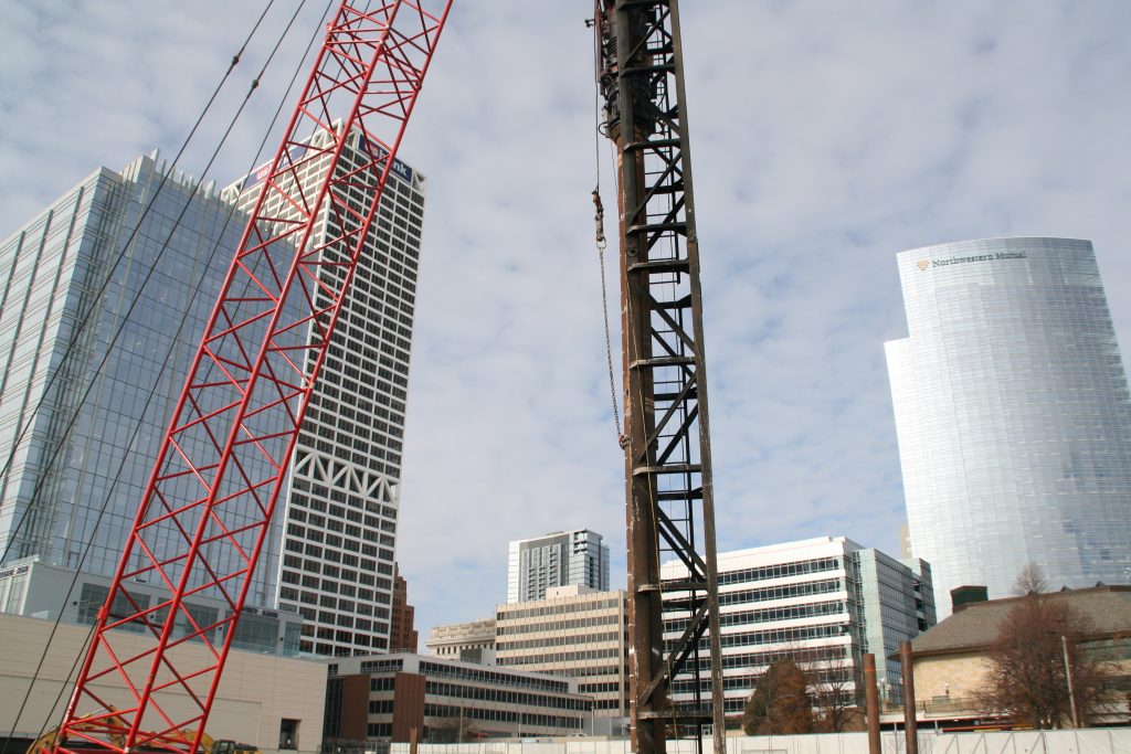 Pile driver at The Couture site and the Milwaukee skyline. Photo by Jeramey Jannene.