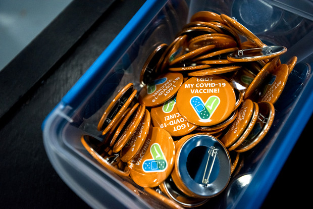 Buttons for people who receive the COVID-19 vaccine are on display Tuesday, May 4, 2021, at St. Francis High School in St. Francis, Wis. Angela Major/WPR