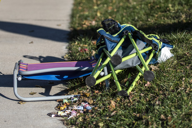 A folding chair and candy remain on a sidewalk near the Christmas parade route Monday, Nov. 22, 2021, in Waukesha, Wis. Angela Major/WPR