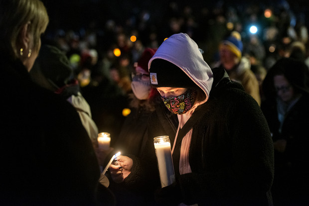 Jennifer Martinez of Waukesha, Wis., lights a candle during a community vigil Monday, Nov. 22, 2021, at Cutler Park in Waukesha, Wis. Martinez’s family member present at the Christmas parade was able to leave unharmed. “It brings me joy to see everybody here,” she said referring to the crowd present at the vigil. Angela Major/WPR