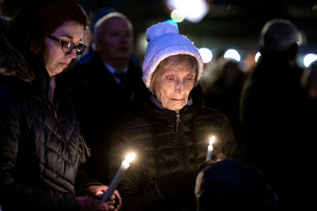 Waukesha residents Christine Thompson, left, and her grandmother Mary Boie, right, stand with lit candles during a vigil Monday, Nov. 22, 2021, in Waukesha, Wis. Angela Major/WPR