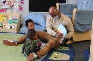 Jeremy Walton reads a book with two of his students at Next Door. Photo by Matt Martinez/NNS.