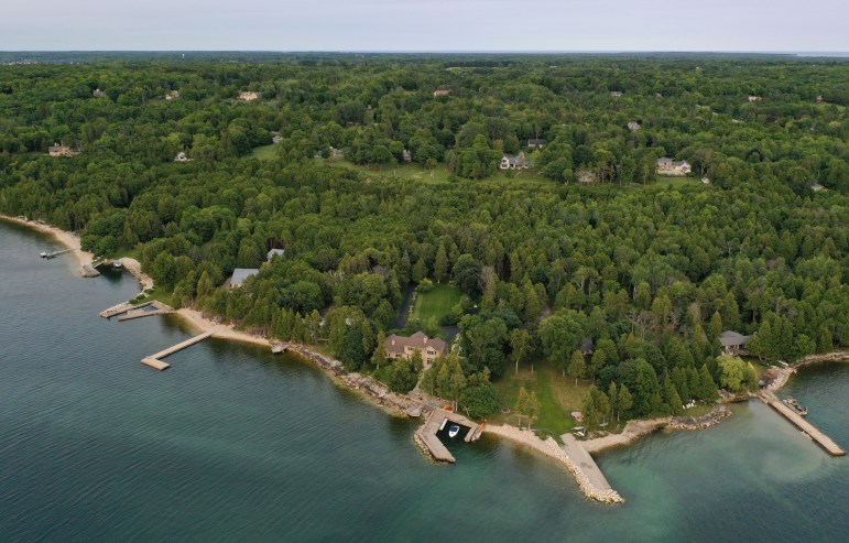 Lakeshore homes are seen in the Door County, Wis., village of Ephraim, on July 31, 2021. Many homeowners have placed large rocks along the shoreline to confront erosion amid wild swings in Lake Michigan’s water levels in recent years. Coburn Dukehart and Tad Dukehart / Wisconsin Watch