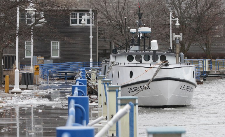 The J.B. Nelson is nearly level with a boardwalk along the Sheboygan River on Jan. 9, 2020 in Sheboygan, Wis. The swollen river flows into Lake Michigan, whose waters reached record heights in 2020 — less than a decade after dredging crews cleared passages for boats due to low water levels. Gary C. Klein / USA TODAY NETWORK-Wisconsin