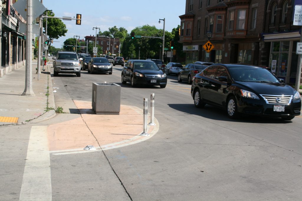 Painted curb extensions, plastic delineators and concrete planter on N. 27th St. Photo by Jeramey Jannene.