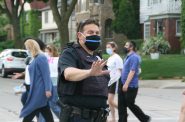 Milwaukee Police Department officer Gary Inman wears a thin blue line mask while directing traffic in June 2020. Photo by Jeramey Jannene.