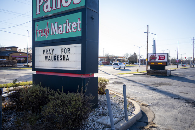 A sign outside of a local business acknowledges the Christmas parade tragedy Monday, Nov. 22, 2021, in Waukesha, Wis. Angela Major/WPR