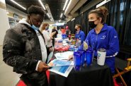 Denzel Martin, left, of Oshkosh, Wis., discusses job opportunities with Jenna Thiel, a talent acquisition business partner lead with Amcor, during the Oshkosh Area Employment Fair on Oct. 12, 2021 at the Oshkosh Arena in Oshkosh. Dan Powers / USA TODAY NETWORK-Wisconsin