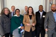 Karen Dettmer, center with plaque, accepts a Wisconsin Policy Forum award with MWW staff. Photo from Milwaukee Water Works.