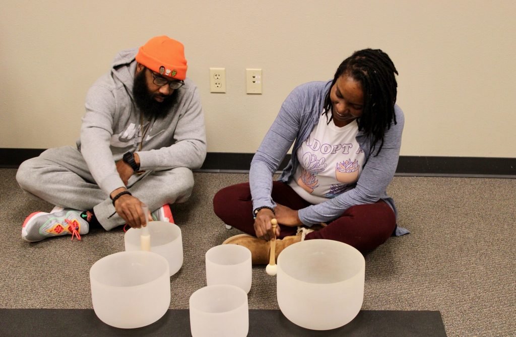Greg Powell II and Camille Mays use singing bowls at their healing space, the Zen Den. Photo by Matt Martinez/NNS.