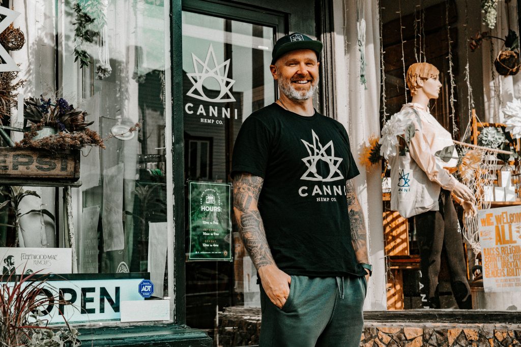 Colin Plant in front of Canni Hemp Co. Photo by Sarah Rose Photography.