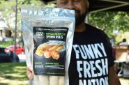 Trueman McGee with package of spring rolls at a farmers' market. Photo from Funky Fresh.