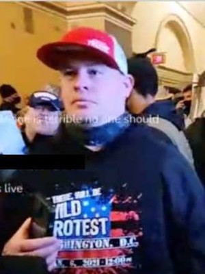 Michael Fitzgerald of Janesville wore a custom T-shirt promising "wild protest" at the insurrection of Jan. 6, 2021, according to an image in court documents pulled from an internet livestream. Photo via U.S. Justice Department court documents/WPR
