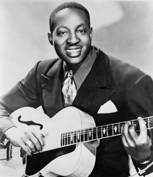 Publicity portrait of American blues musician Big Bill Broonzy, 1951, with a Gibson L-7 guitar. James J. Kriegsmann, Public domain, via Wikimedia Commons