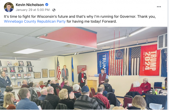 Gubernatorial candidate Kevin Nicholson speaks in front of the flag of the Three Percenters, which represents and anti-government ideology. (Screenshot | Kevin Nicholson Facebook)