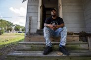 Reginald Reed sits on the steps of a home he’s remodeling in a Milwaukee neighborhood Thursday, Aug. 5, 2021. Angela Major/WPR