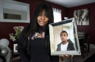 Kenosha resident Romonda Thomas holds a photo of her brother, Turando Long, who was killed in 2021. Angela Major/WPR