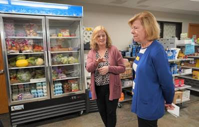 Baldwin touring the Iowa County Food Pantry with staff. 