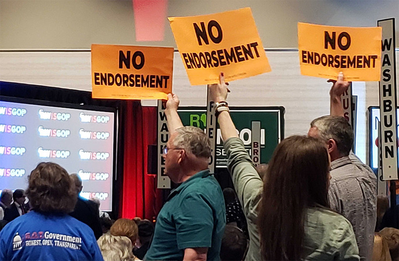 Republican activists hold up signs encouraging no endorsement of a GOP candidate for governor Saturday during the Wisconsin Republican Convention in Middleton. Shawn Johnson/WPR