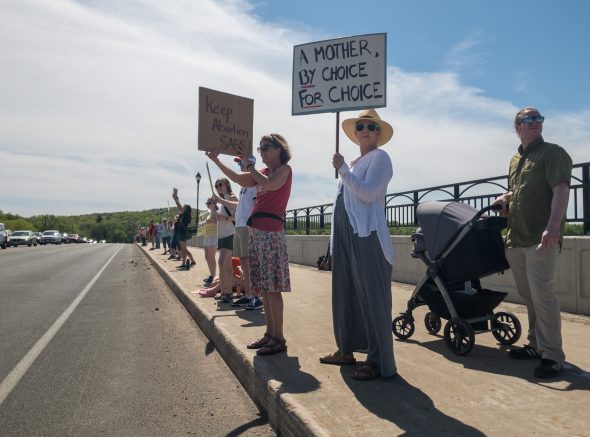 Pro-choice protesters wave to passing traffic on the Highway 12 bridge over the Wisconsin River at Sauk City on Saturday, May 14, to voice support for legal abortion access. Photo by Christina Lieffring/Wisconsin Examiner.