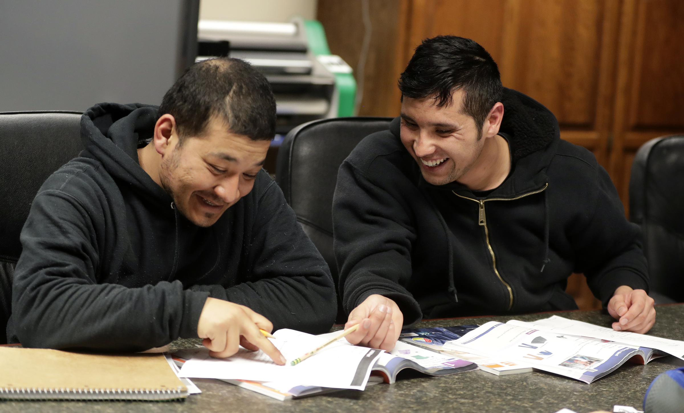 Mohammad Ali Afshar, right, and Hedaiatullah Azim participate in an English class on April 14, 2022, at Faith Lutheran Church in Allouez, Wis. Before fleeing the country, both defended the U.S. Embassy in Kabul as part of the Afghanistan military’s special operations, said Mike Ruminski, who has helped Afghan evacuees obtain their driver’s licenses, enroll in English classes and connect with job specialists. (Sarah Kloepping/USA TODAY NETWORK-Wisconsin)