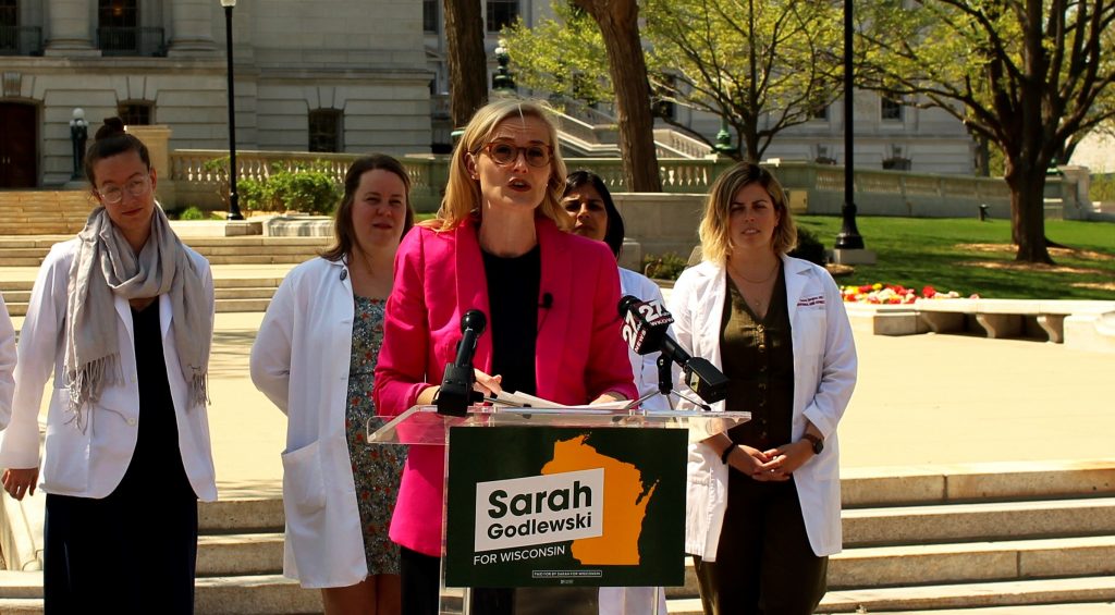 Flanked by a group of medical doctors, Sarah Godlewski speaks at a press conference May 13, 2022, on preserving abortion rights. Godlewski is campaigning for the Democratic nomination to run for Senate against Republican Sen. Ron Johnson. Photo by Henry Redman/Wisconsin Examiner.