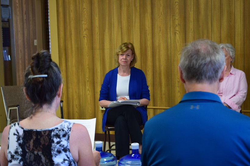 U.S. Sen. Tammy Baldwin, D-Wis., listens to residents from the Town of Campbell who have PFAS contamination in their private wells during a listening session on Friday, May 13, 2022. Hope Kirwan/WPR
