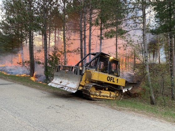 A DNR tractor-plow digs a fireline to contain a fire on May 14 in partnership with Menominee Tribal Enterprises. Please avoid burning due to very high fire danger. / Photo Credit: Wisconsin DNR