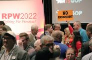 A woman holds up a "NO ENDORSEMENT" sign at the 2022 Wisconsin Republican Party Convention. Shawn Johnson/WPR