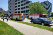Fire trucks and emergency vehicles are positioned near Aurora St. Luke's Medical Center as dive teams search for three people washed away by high waters in a drainage ditch. Christine Hatfield/WPR