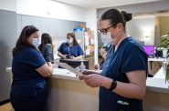 Clinic coordinator Emily Estrada reads a list of staff duties before the clinic opens Friday, May 27, 2022, at Planned Parenthood’s Water Street Health Center in Milwaukee, Wis. Angela Major/WPR