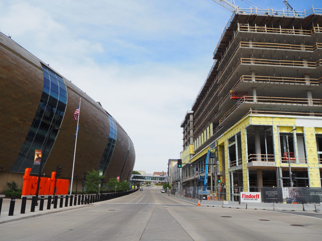 The Trade is rising over Fiserv Forum and W. Juneau Ave. Photo by Jeramey Jannene.