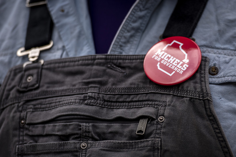 A supporter wears a Tim Michels button outside one of his campaign events Tuesday, July 12, 2022, in Green Bay, Wis. Angela Major/WPR