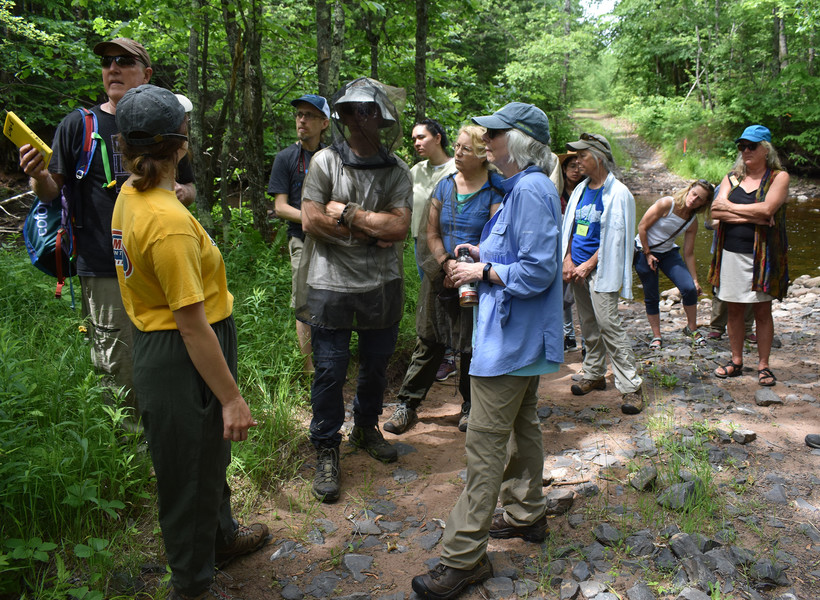 A group of tribal and environmental advocates tour Enbridge's proposed route for its Line 5 project, routing a new 30-inch pipeline around the Bad River reservation. The group gathers where the pipeline would cross the Tyler Forks River on Friday, June 24, 2022. Danielle Kaeding/WPR