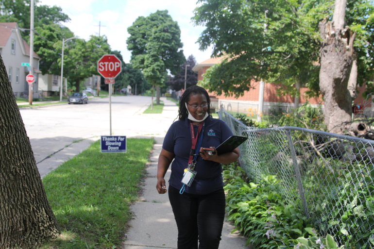 Freda Wright, a program manager for the Eras Senior Network, canvases Milwaukee’s Harambee neighborhood on July 20, 2022, connecting low-income elderly residents with free air conditioners and utility assistance. (Samantha McCabe / Wisconsin Watch)