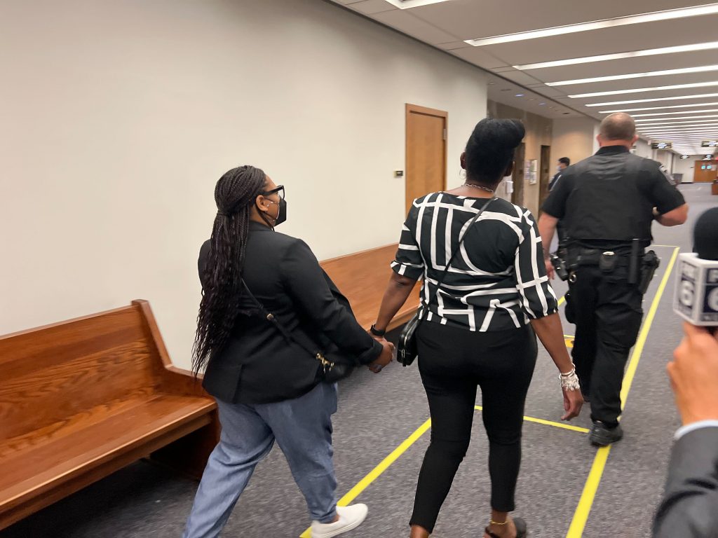 Chantia Lewis, left, leaves the courtroom Thursday. Photo by Jeramey Jannene.