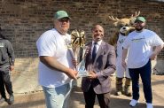 Artreyo "Dimez" Boyd poses with Mayor Cavalier Johnson and the NBA2K championship trophy. Photo by Jeramey Jannene.