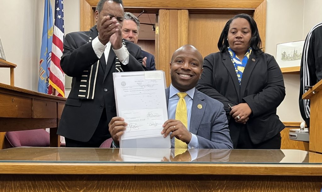 Mayor Cavalier Johnson after signing the Juneteenth ordinance as Treasurer Spencer Coggs, Ald. Michael Murphy and Ald. Milele A. Coggs look on. Photo by Jeramey Jannene.