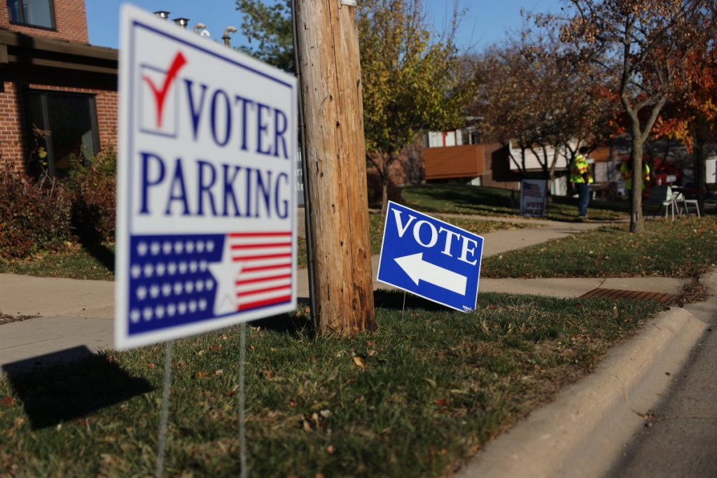 Voting signs are seen outside the polling place at the Catholic Multicultural Center in Madison, Wis., on Nov. 3, 2020. Conservative activists say holes in the state’s voter database have allowed some ineligible voters to cast a ballot. But their efforts also have conflated ineligible and eligible voters and spread misleading information, Wisconsin Watch found. (Coburn Dukehart / Wisconsin Watch)
