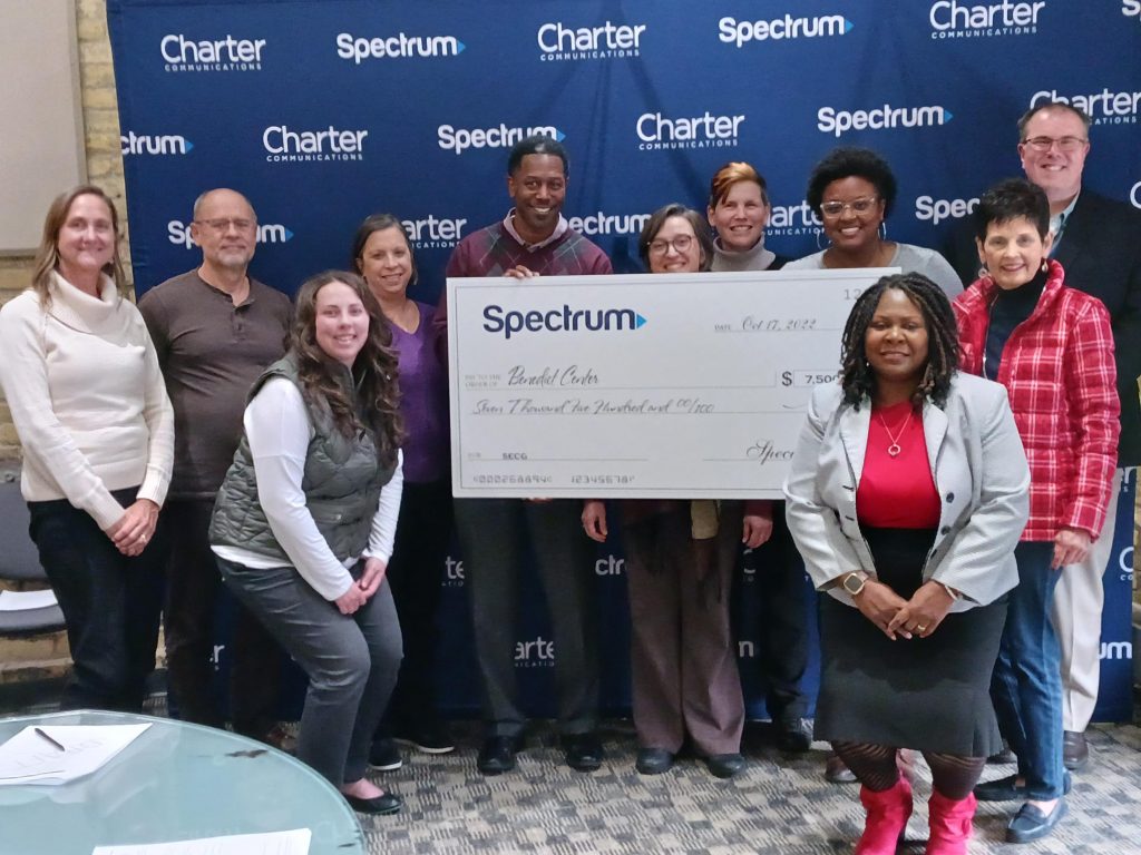 Members of Benedict Center Board of Directors, Benedict Center Executive Director Jeanne Geraci (back row, glasses), Spectrum Vice President of Retention JJ Jonas (back row, center, grey pants), Spectrum Director of Government and Community Strategy, Midwest Region Margaret Bailey-Stewart (lower right). Photo courtesy of Spectrum.
