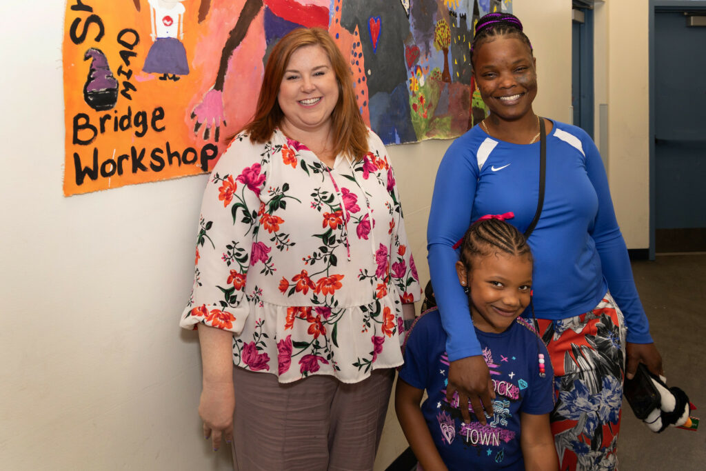 Leslie Mason (left), case manager of Hope House of Milwaukee, poses with a family. The Safe & Stable Homes Initiative seeks to end family homelessness by 2023. Photo by Dan Herda provided by United Way of Greater Milwaukee & Waukesha County/NNS.