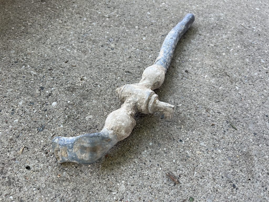 A portion of a lead service line removed from a house on S. 12th St. Photo by Jeramey Jannene.