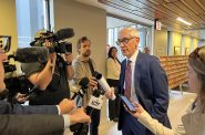 Governor Tony Evers in a media scrum on Oct. 11, 2022. Photo by Jeramey Jannene.