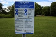A PFAS advisory sign along Starkweather Creek. (Henry Redman | Wisconsin Examiner)