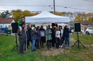 Residents gather to celebrate the installation of new bollards on Cesar Chavez Drive. The bollards memorialize lessons learned during the pandemic and the First Nations and immigrant groups that moved to Milwaukee before 1920. (Photo by Sam Woods)